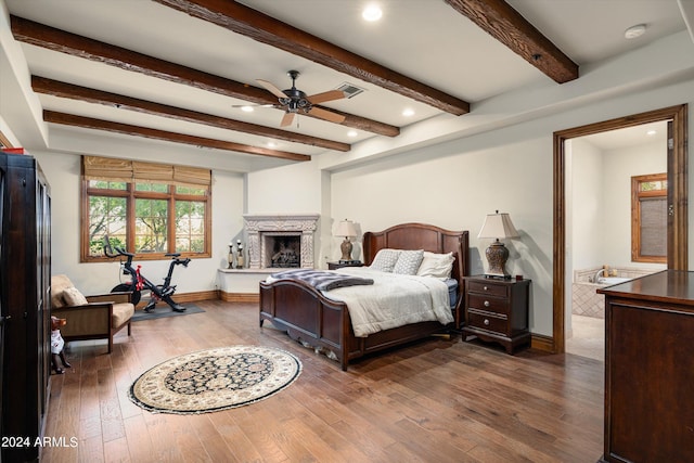 bedroom with ceiling fan, hardwood / wood-style flooring, and beam ceiling