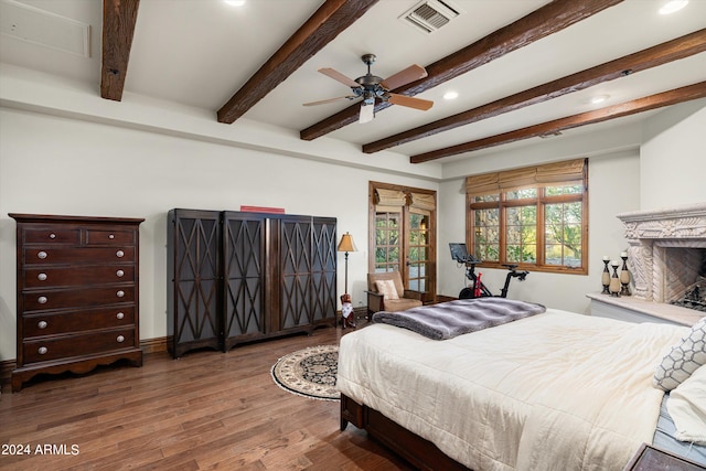 bedroom with beam ceiling, wood-type flooring, and ceiling fan