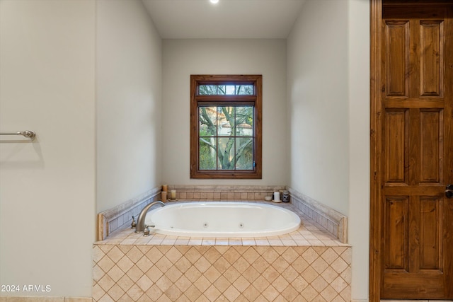 bathroom with a relaxing tiled tub