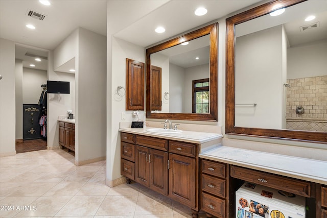 bathroom featuring baseboards, tile patterned flooring, vanity, and visible vents
