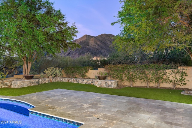 view of swimming pool featuring a mountain view and a patio area