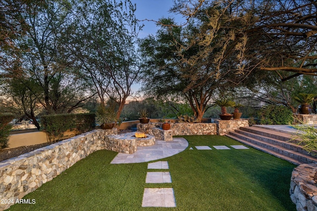 view of yard with an outdoor fire pit and a patio area