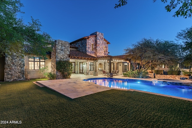 view of swimming pool with a patio area, an in ground hot tub, and a lawn