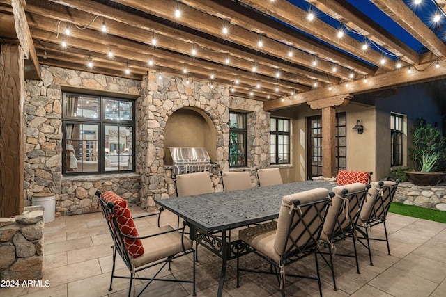 view of patio with exterior kitchen, outdoor dining area, and a pergola
