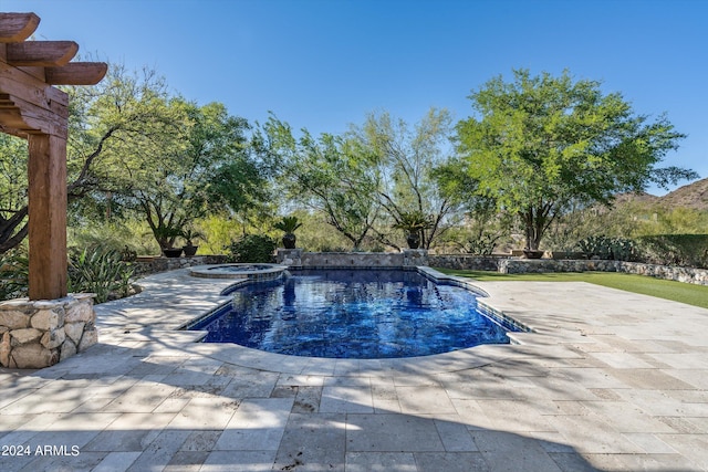 view of pool with a pool with connected hot tub and a patio area
