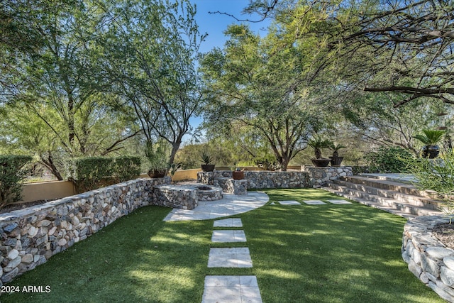 view of yard featuring an outdoor fire pit and a patio