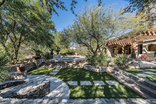 view of yard featuring a patio area and an in ground hot tub