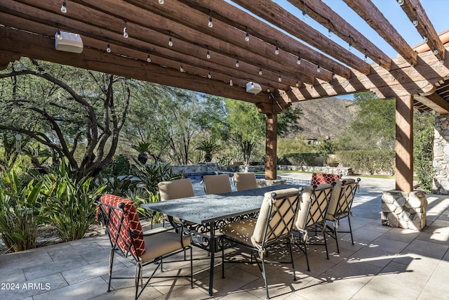 view of patio / terrace with a pergola and a mountain view