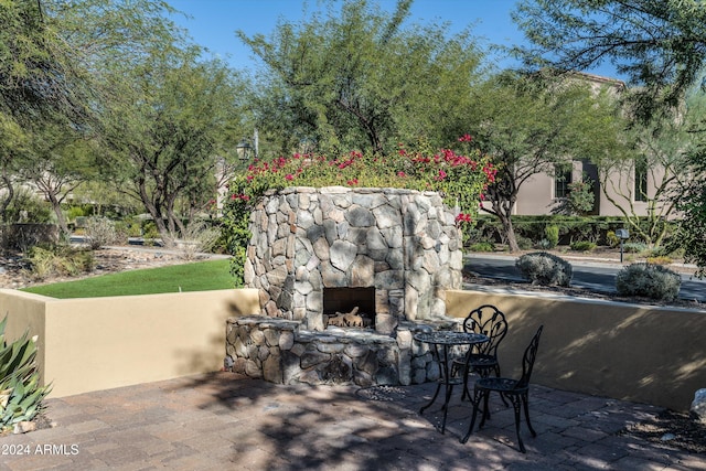 view of patio / terrace featuring an outdoor stone fireplace