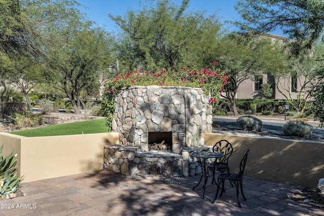 view of patio with an outdoor stone fireplace