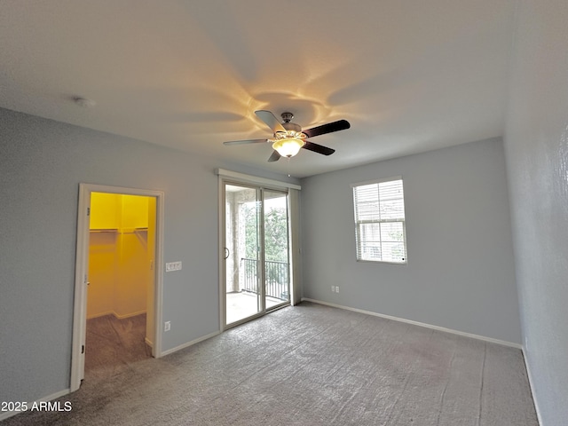 carpeted spare room with baseboards and ceiling fan