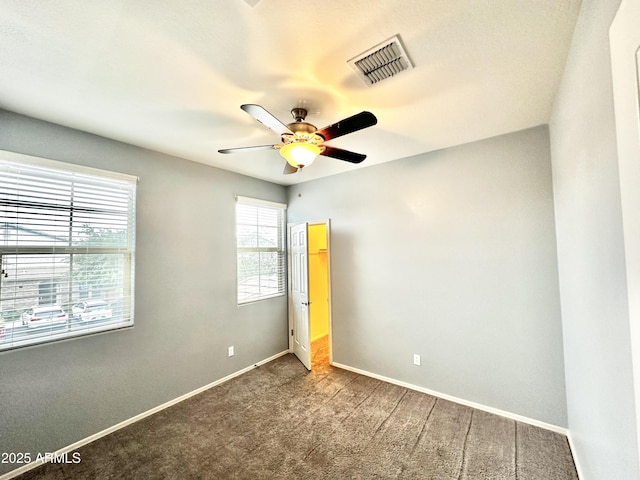 unfurnished bedroom with visible vents, baseboards, carpet flooring, and ceiling fan