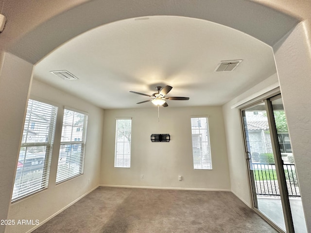 unfurnished room featuring carpet flooring, baseboards, and visible vents