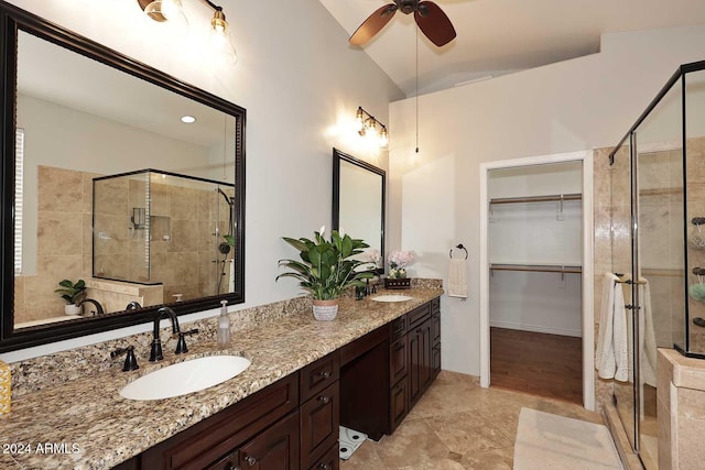 bathroom with ceiling fan, an enclosed shower, vanity, and vaulted ceiling