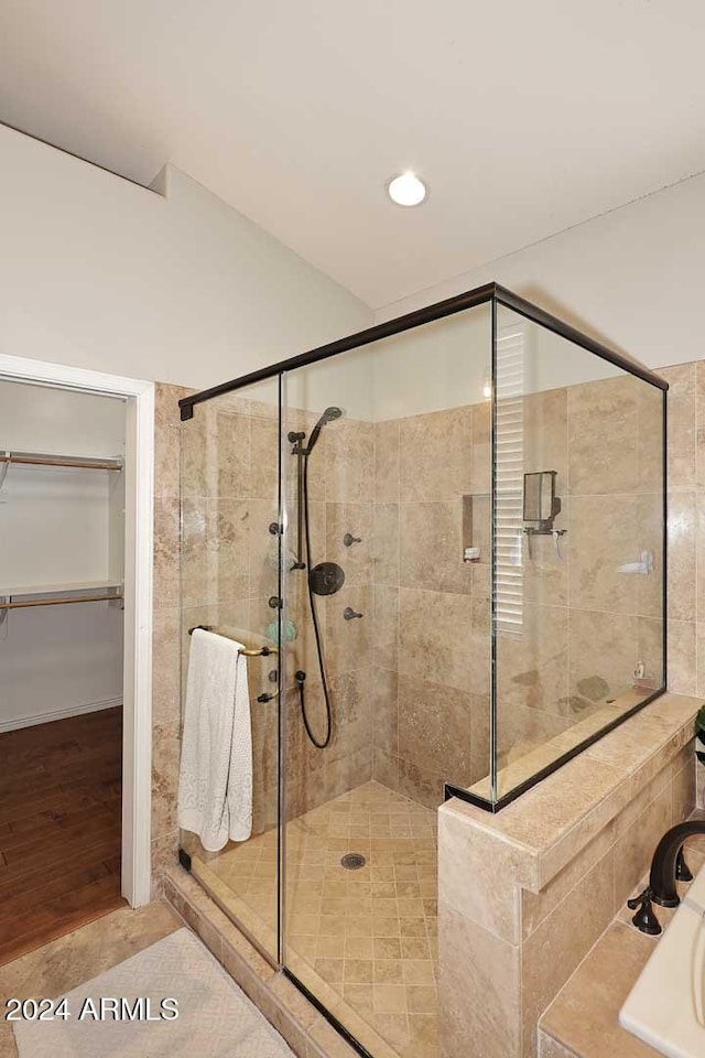 bathroom with tile patterned flooring and walk in shower