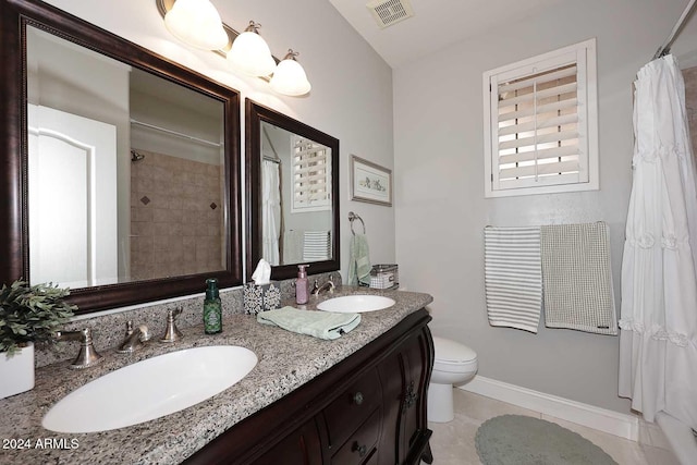 bathroom with tile patterned flooring, vanity, toilet, and curtained shower