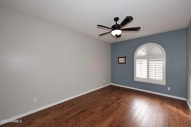 empty room featuring ceiling fan and dark wood-type flooring