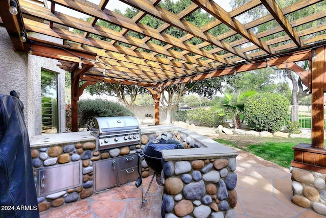 view of patio / terrace featuring a pergola, exterior kitchen, and grilling area