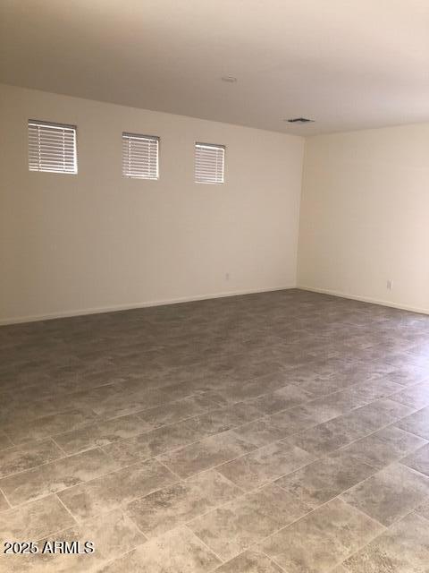 spare room with baseboards