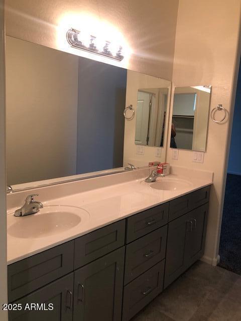 full bath with double vanity and a sink