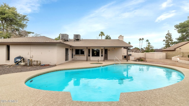 view of swimming pool with a patio, central AC, a fenced backyard, and a fenced in pool