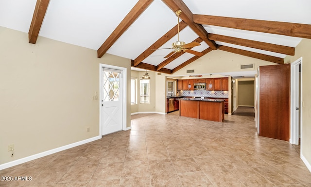 kitchen featuring visible vents, dark countertops, ceiling fan, stainless steel microwave, and backsplash