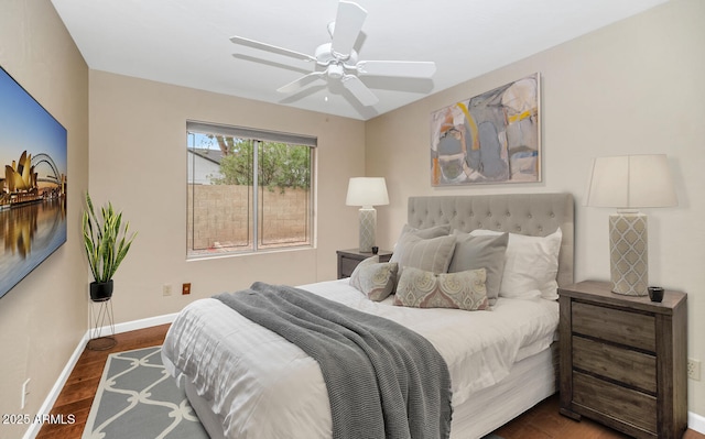 bedroom with ceiling fan, wood finished floors, and baseboards