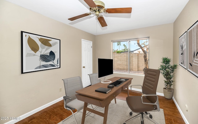 office space featuring ceiling fan, wood finished floors, and baseboards