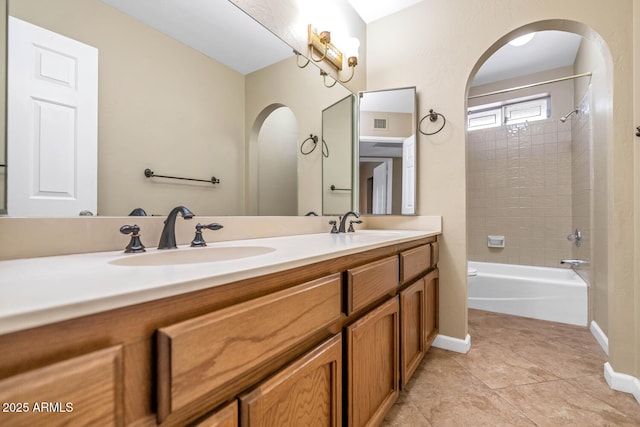 full bathroom featuring double vanity, baseboards, tile patterned floors, shower / bathtub combination, and a sink