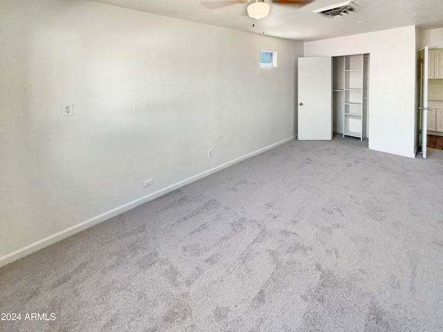 unfurnished bedroom with light carpet, ceiling fan, and a closet