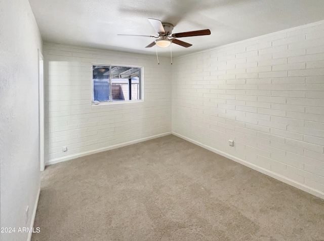 carpeted spare room with baseboards, a textured ceiling, and ceiling fan