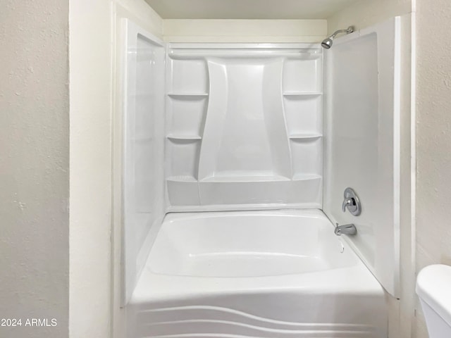 bathroom featuring  shower combination and toilet