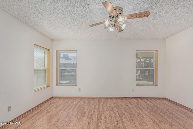 4207 W Soft Wind Dr, Glendale, AZ 85310 - empty room with a textured ceiling, ceiling fan, light wood-type flooring, and baseboards