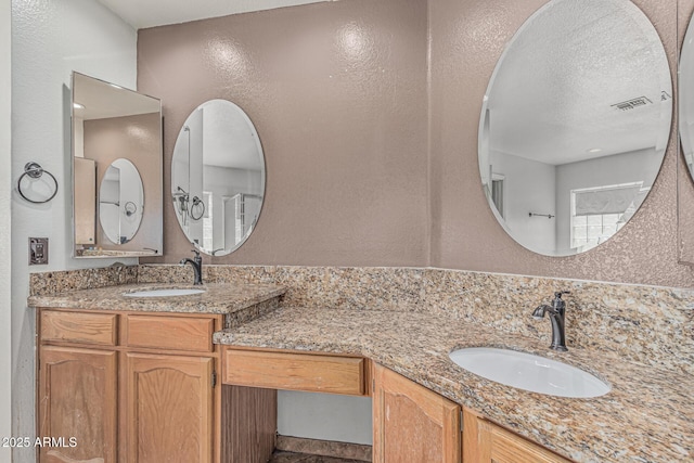 4207 W Soft Wind Dr, Glendale, AZ 85310 - bathroom with a textured wall, vanity, and a textured ceiling