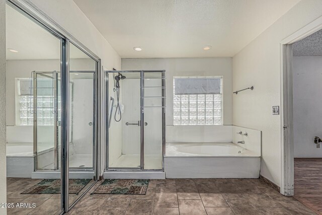 4207 W Soft Wind Dr, Glendale, AZ 85310 - bathroom with a garden tub, a stall shower, and recessed lighting