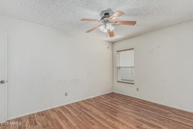 4207 W Soft Wind Dr, Glendale, AZ 85310 - unfurnished room featuring a textured ceiling, wood finished floors, ceiling fan, and baseboards