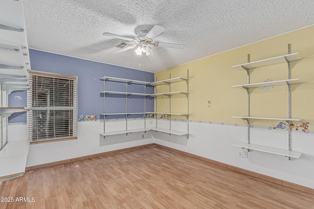 4207 W Soft Wind Dr, Glendale, AZ 85310 - spare room featuring a ceiling fan, wood finished floors, a textured ceiling, and baseboards