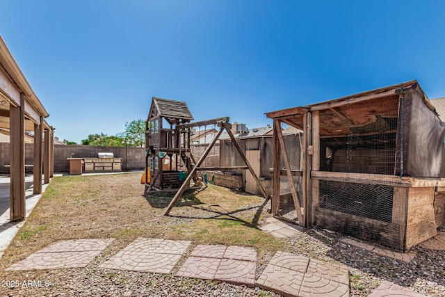 4207 W Soft Wind Dr, Glendale, AZ 85310 - fenced backyard featuring exterior structure, an outbuilding, and a playground