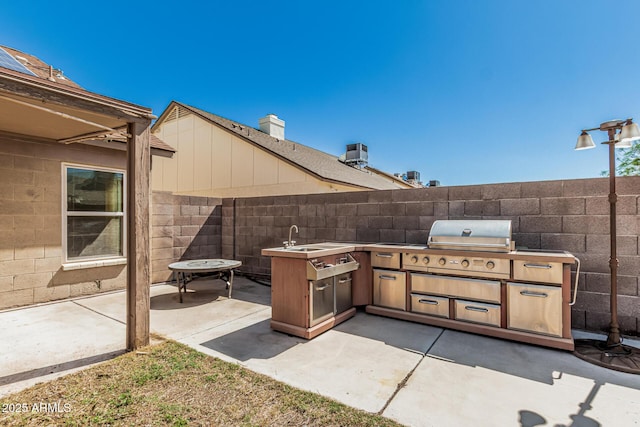 4207 W Soft Wind Dr, Glendale, AZ 85310 - view of patio / terrace with an outdoor kitchen, fence, a grill, and a sink