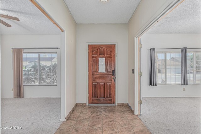 4207 W Soft Wind Dr, Glendale, AZ 85310 - entryway featuring a textured ceiling, ceiling fan, carpet floors, and baseboards