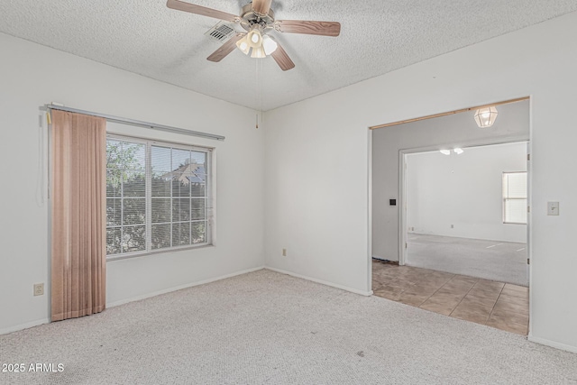 4207 W Soft Wind Dr, Glendale, AZ 85310 - carpeted spare room with a textured ceiling, ceiling fan, tile patterned flooring, and baseboards