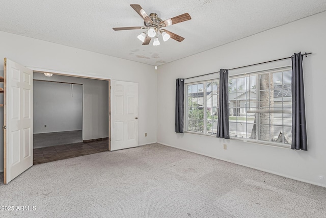 4207 W Soft Wind Dr, Glendale, AZ 85310 - unfurnished bedroom with carpet floors, a textured ceiling, a closet, ceiling fan, and baseboards