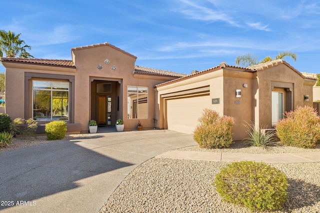 mediterranean / spanish home featuring a garage