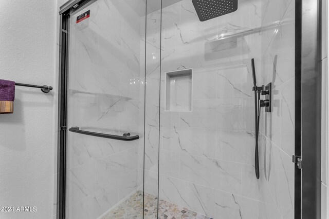 bathroom featuring a shower with shower door