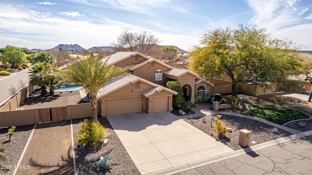 view of front facade with a garage and a mountain view