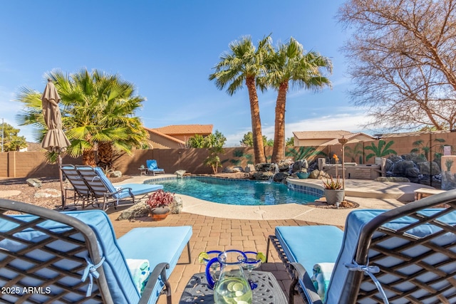 view of pool featuring pool water feature and a patio