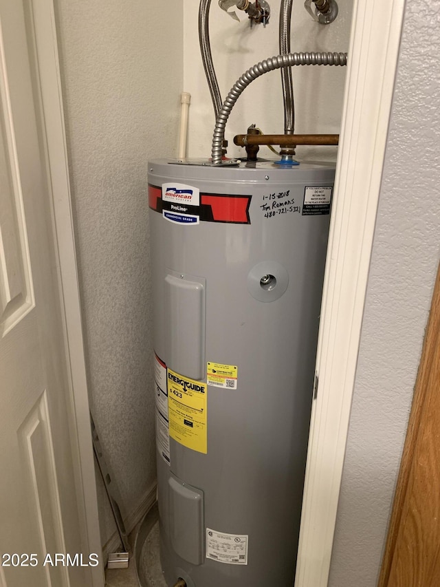 utility room featuring water heater