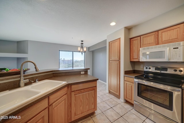 kitchen featuring pendant lighting, sink, stainless steel range with electric cooktop, light tile patterned floors, and a notable chandelier