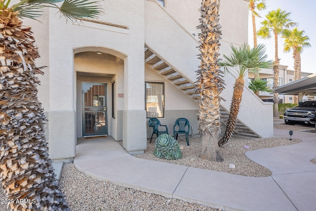 property entrance with stucco siding