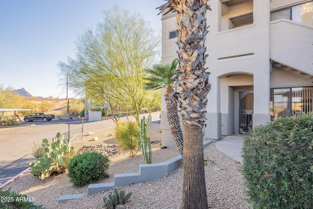 doorway to property featuring a mountain view and stucco siding